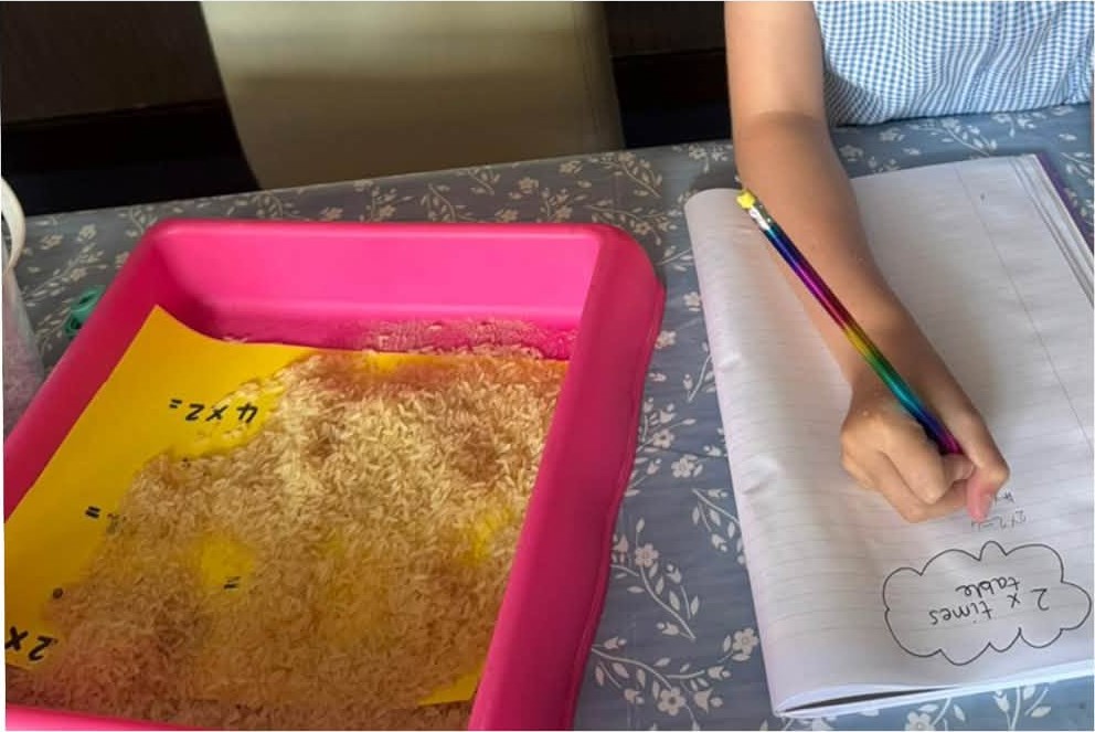 Times tables practice with a tray of coloured rice