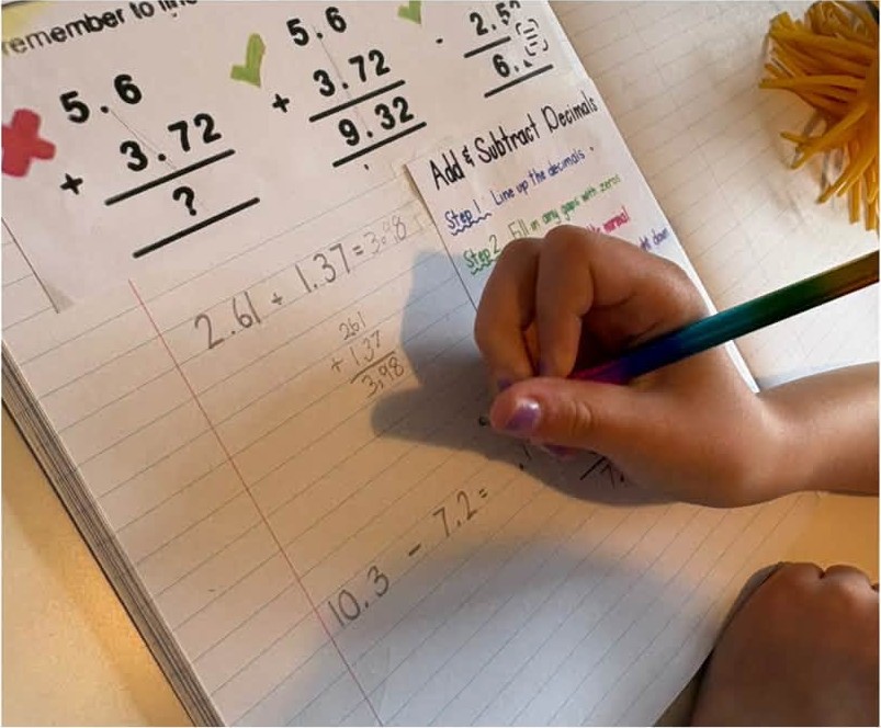 Adding decimals in a maths workbook